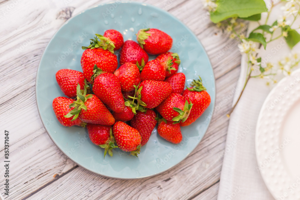 strawberries in a bowl on wooden table strawberries in a bowl on wooden table