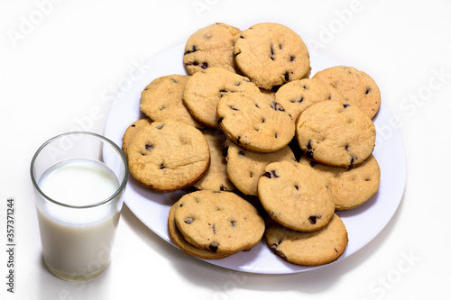 Delicious chocolate chip cookies plate with a glass of milk.  on a white Isolated background