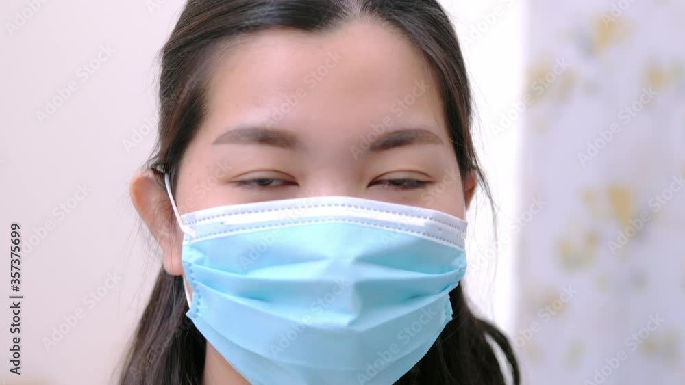 Beautiful Asian woman wearing a mask look camera and relaxing stay on the bed at home lifestyle and pleasure concept. Beautiful Asian woman wearing a mask look camera and relaxing stay on the bed at home lifestyle and pleasure concept.