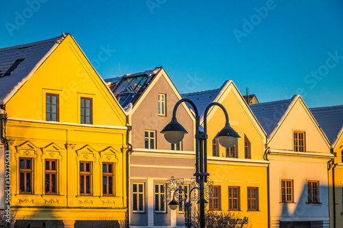 Historic burgher houses on the square lit by the morning sun. City of Zilina, Slovakia, Europe.