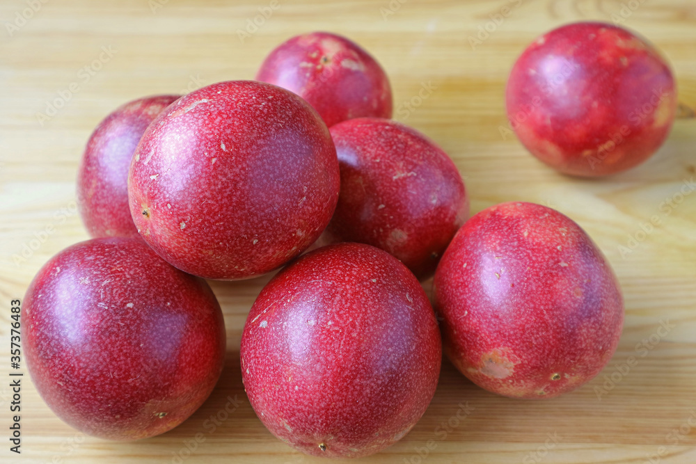 Pile of Fresh Ripe Passion Fruits on Wooden Table Pile of Fresh Ripe Passion Fruits on Wooden Table