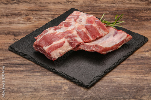 Raw pork ribs served rosemary