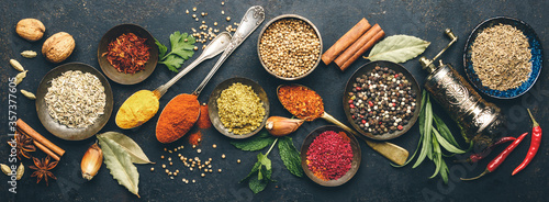 Herbs and spices on dark background photo