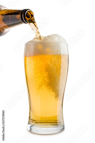 Fototapeta pouring blonde beer into glass, isolated on white background