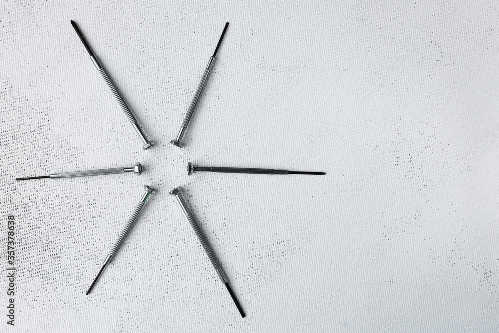 a set of small screwdrivers for repairing small household appliances at home. On a worn white background. Flatley. a set of small screwdrivers for repairing small household appliances at home. On a worn white background. Flatley.