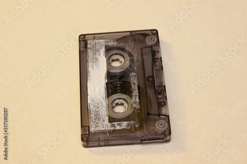 Old audio cassette lehit on a yellow background