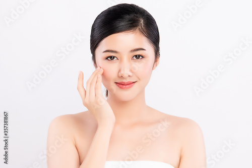 Beautiful Young asian Woman touching her clean face with fresh Healthy Skin, isolated on white background, Beauty Cosmetics and Facial treatment Concept.