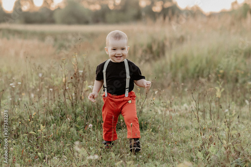 cute little baby boy smiling in autumn field