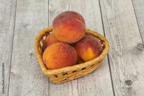 Peach heap in the wooden basket