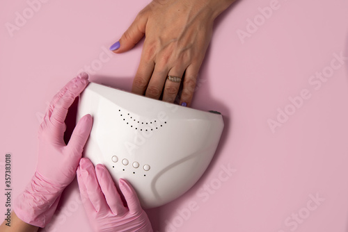 Manicure process on pink background, top view.Manicure in beauty salon.Manicure concept,