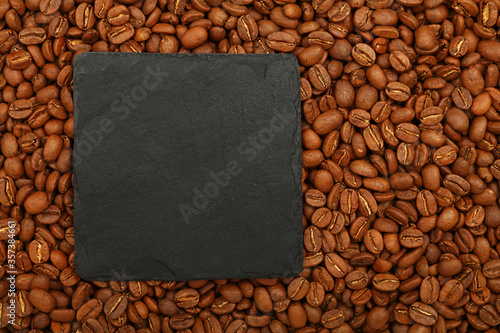 Black slate board sign over roasted coffee beans