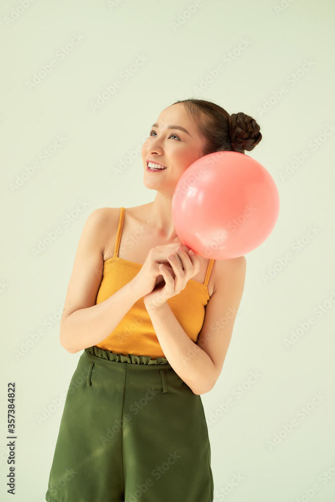 Portrait of attractive lovely gilr holding air balloon against light background. Portrait of attractive lovely gilr holding air balloon against light background.