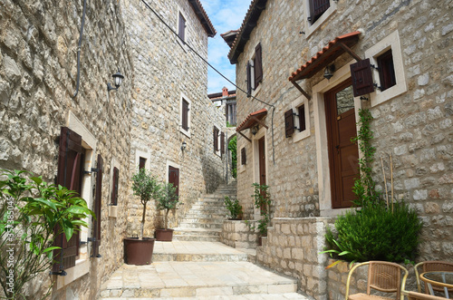Fototapeta Naklejka Na Ścianę i Meble -  One of the streets in the old city of Ulcinj in summer on a Sunny day. Montenegro