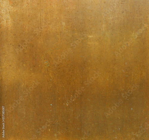 ancient golden metal surface with orange and yellow tones - worn background