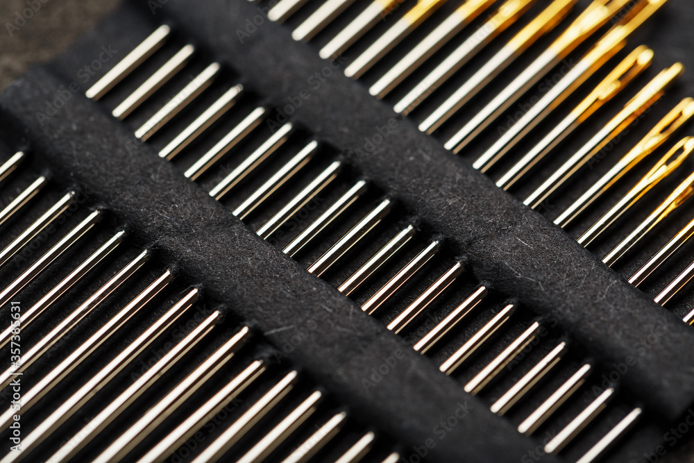 Set of Gold needles on a black background in a row. Set of Gold needles on a black background in a row.