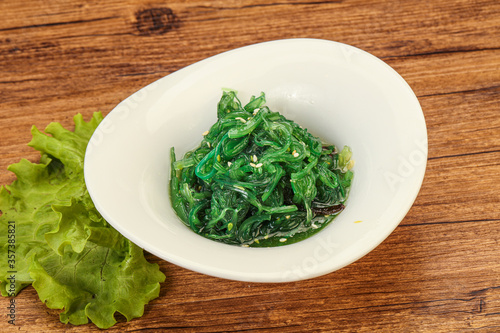 Green Chuka Seaweed Salad Isolated on White Background Top View. Wakame Sea Kelp Salat