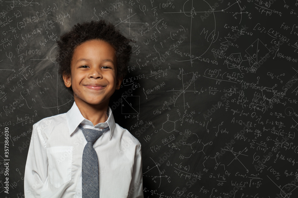 Smart kid student boy on chalkboard background with science formulas Smart kid student boy on chalkboard background with science formulas