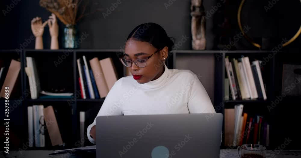 Freelance work concept. Zoom in portrait of beautiful young smart African woman using laptop to work online slow motion. Freelance work concept. Zoom in portrait of beautiful young smart African woman using laptop to work online slow motion.