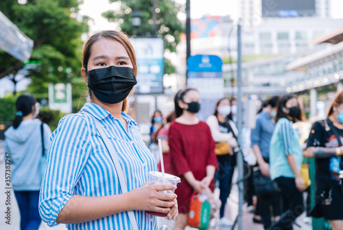 young asian woman with mask walking in the Bangkok city 