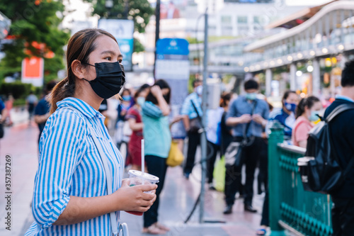 Wallpaper Mural young asian woman with mask  walking in the Bangkok city   Torontodigital.ca