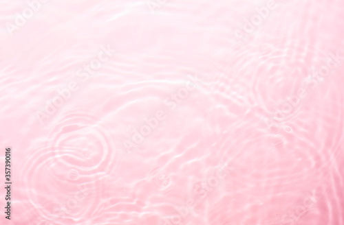 Pink splashing cosmetic moisturizer, micellar water, toner, or emulsion background