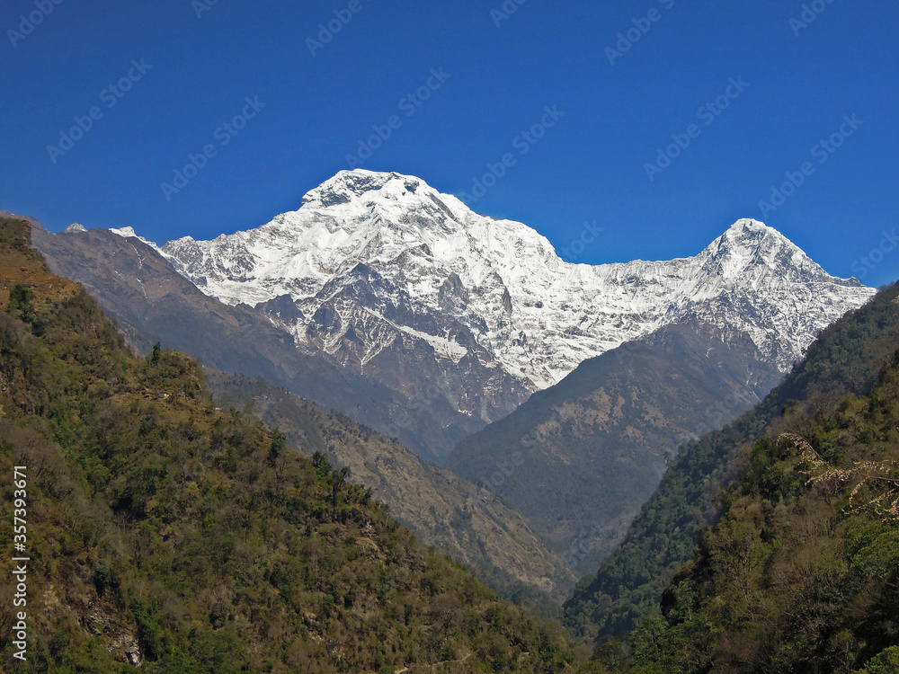 Panoramic view on the snowy top of Annapurna and the other nameless mountains and hills nearby, Nepal, Himalaya