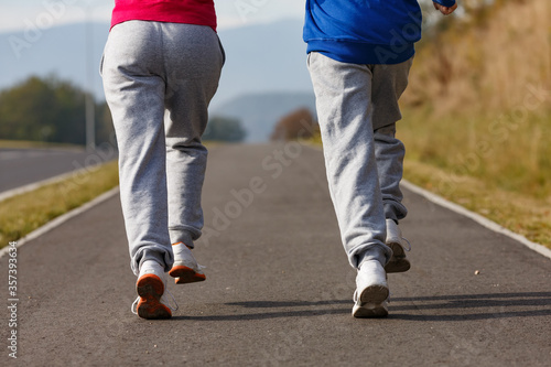 Girl and boy running, jumping outdoor 