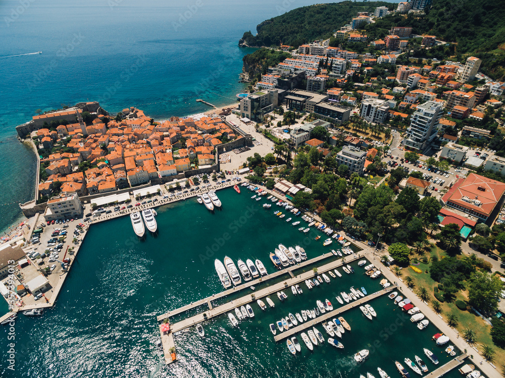 The old town of Budva and the pier for boats and yachts on the waterfront.