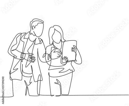 One continuous line drawing of young startup members check the work each others using laptop and tablet. Business process teamwork concept. Single line draw design vector illustration