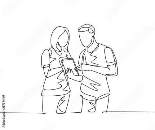 One continuous line drawing of young male and female employee talking about company target while staring tablet screen. Business goal discussion concept single line draw design vector illustration