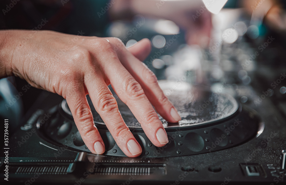 DJ Hands creating and regulating music on dj console mixer in concert nightclub stage DJ Hands creating and regulating music on dj console mixer in concert nightclub stage
