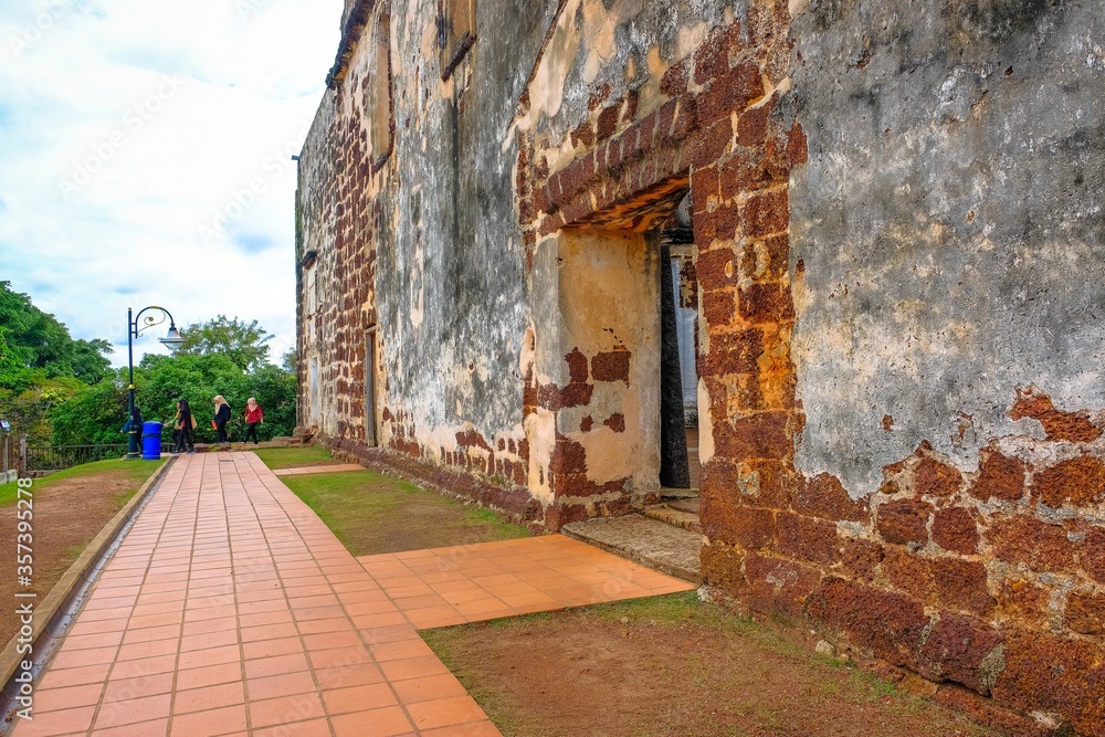 Low angle image old external brick wall of the ruin of st paul church in malacca malaysia. Blue sky in visibility. Focus selective on old wall