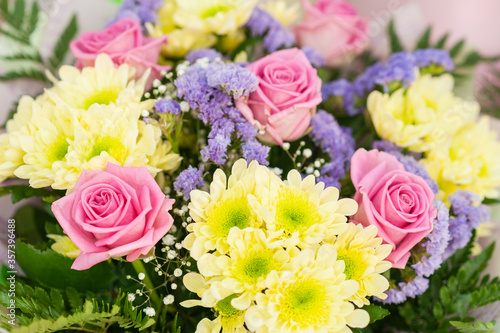 Colorful flower bouquet on the shelf. Flower business. Multi-colored bouquet. Selective focus. Macro photo.