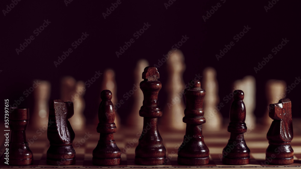 Wooden chess in a contrasting light. A game of chess, an intellectual competition, Wooden chess in a contrasting light. A game of chess, an intellectual competition,