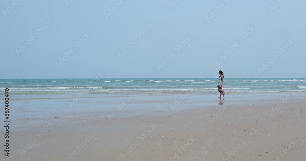 Asian woman walk on the beach