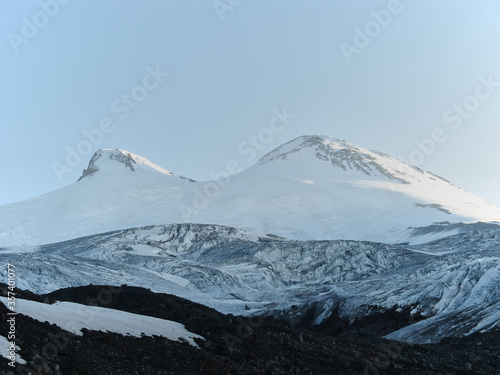 Mountains Landscape Travel aerial view from north side of Elbrus mount serene scenery wild nature calm idyllic scene. Snow-covered beautiful mountains.