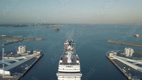 A stunning aerial view of a tourist liner in open water, top view. The front and top of a floating ocean liner floating in the ocean. Aerial footage of a white liner. Stocks. photo