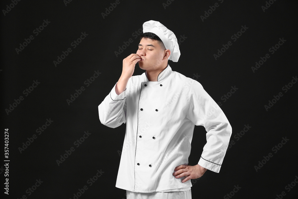 Handsome Asian chef on dark background Handsome Asian chef on dark background