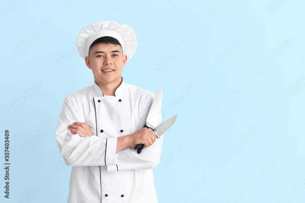 Handsome Asian chef on color background Handsome Asian chef on color background