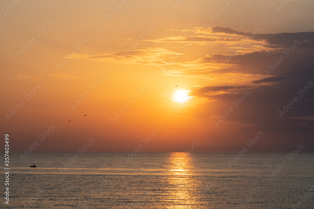Fototapeta premium Golden sunset on the seashore. Evening Seascape, calm sea.