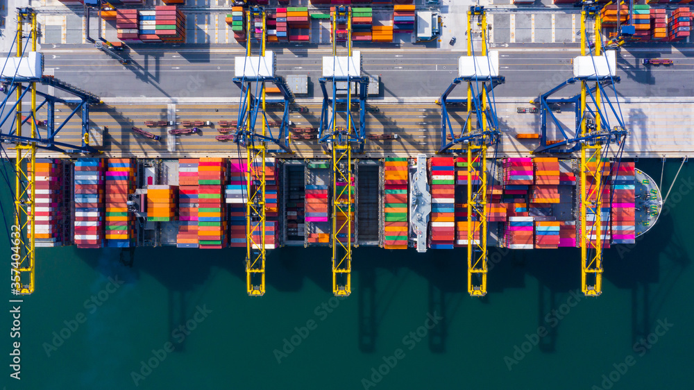 Container ship at industrial port in import export global business worldwide logistic and transportation, Container ship unloading freight shipment, Aerial view container cargo vessel boat freight.