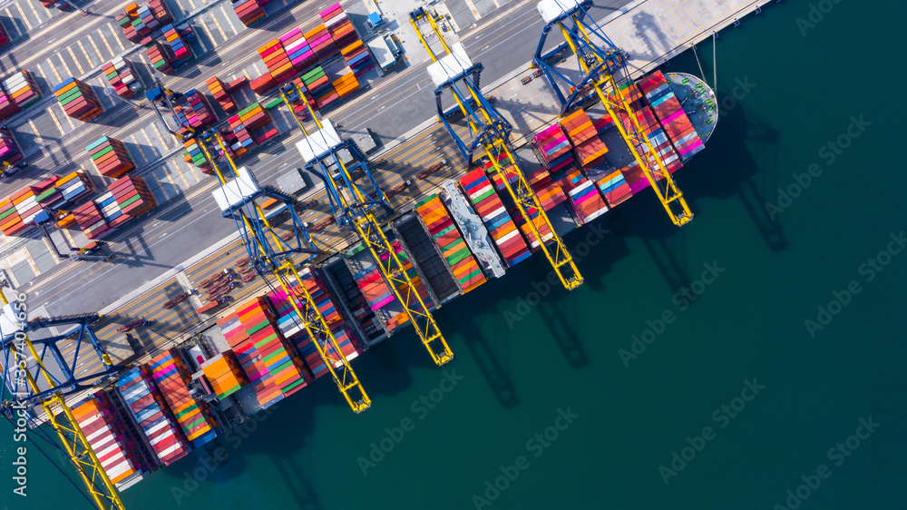 Container ship at industrial port in import export global business worldwide logistic and transportation, Container ship unloading freight shipment, Aerial view container cargo vessel boat freight. Container ship at industrial port in import export global business worldwide logistic and transportation, Container ship unloading freight shipment, Aerial view container cargo vessel boat freight.