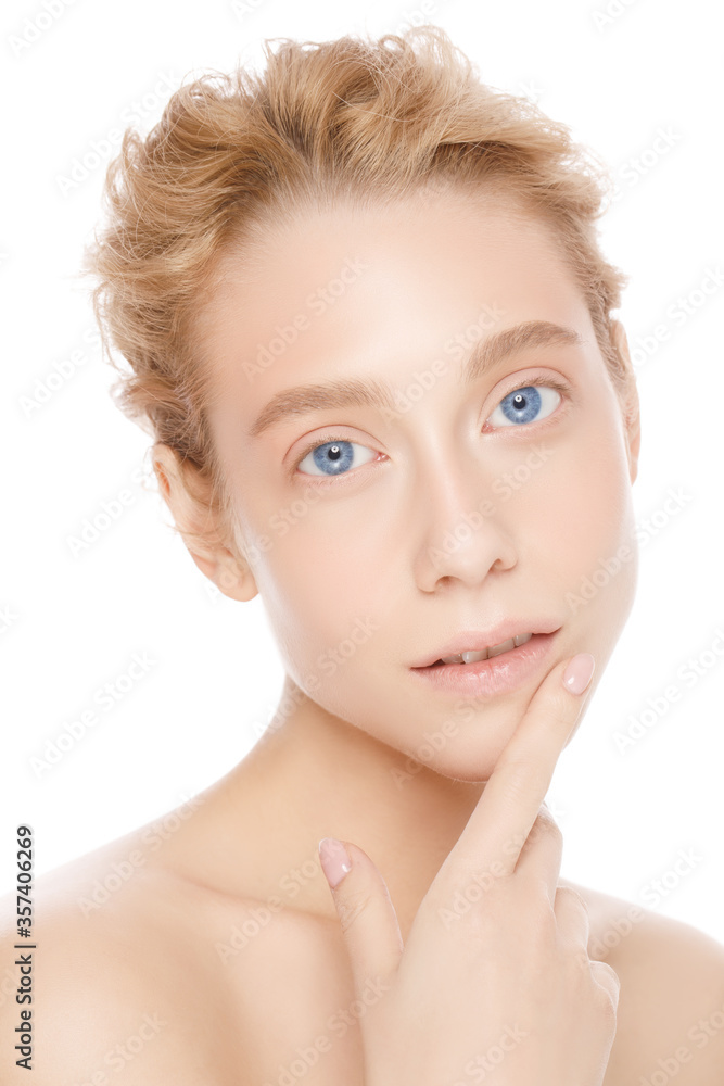 Vertical portrait of young beautiful woman with blond hair and blue eyes, standing with naked shoulders, touching lip with finger, isolated on white background Vertical portrait of young beautiful woman with blond hair and blue eyes, standing with naked shoulders, touching lip with finger, isolated on white background