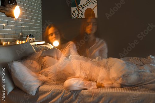 Female sleepwalker in bedro...
