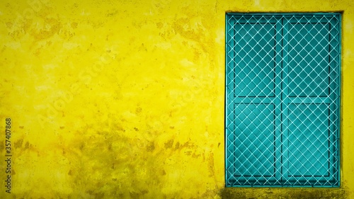 yellow wall with copy space and colorful window