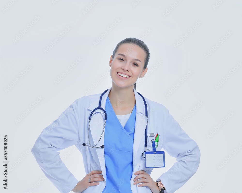 Beautiful young woman in white coat posing with hand in pocket. Woman doctor Beautiful young woman in white coat posing with hand in pocket. Woman doctor