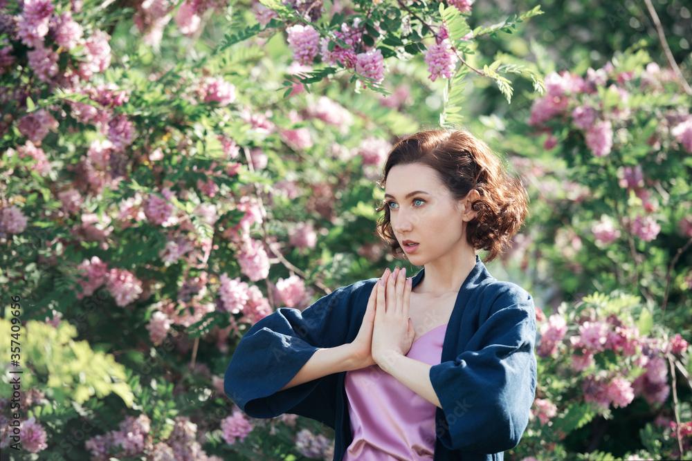 Young beautiful dreamy girl on a background of blooming acacia. Outdoor portrait of romantic woman. Young beautiful dreamy girl on a background of blooming acacia. Outdoor portrait of romantic woman.