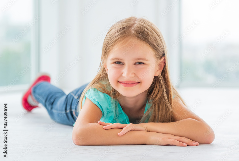 Smiling school girl with crossed hands staring at you Smiling school girl with crossed hands staring at you