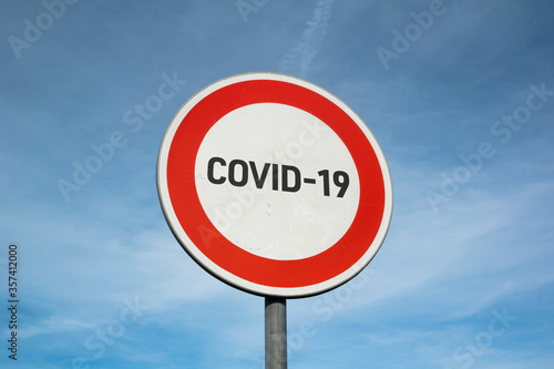 Stop coronavirus. Warnign traffic sign with Covid-19 - No trespassing for virus, infection. Viral disease is forbidden, banned, prohibited and eliminated.