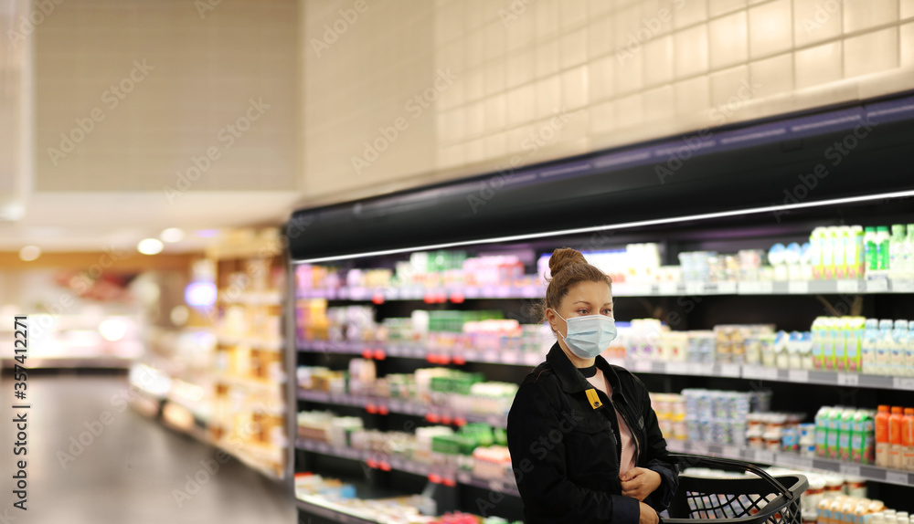 supermarket shopping, face mask and gloves,Woman choosing a dairy products at supermarket			